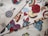 A collection of fabric swatches featuring various colorful designs. The patterns include a stylized hot air balloon, a rose, a rainbow, yin-yang symbol, pizza slice, a heart with flames, vintage cars, and other assorted graphics. The designs are vibrant and eclectic, with a mix of traditional and pop culture elements.