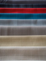 Rows of textile samples displaying different chemical finishes and textures.