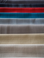 An array of fabric swatches used in the shirt-making process.