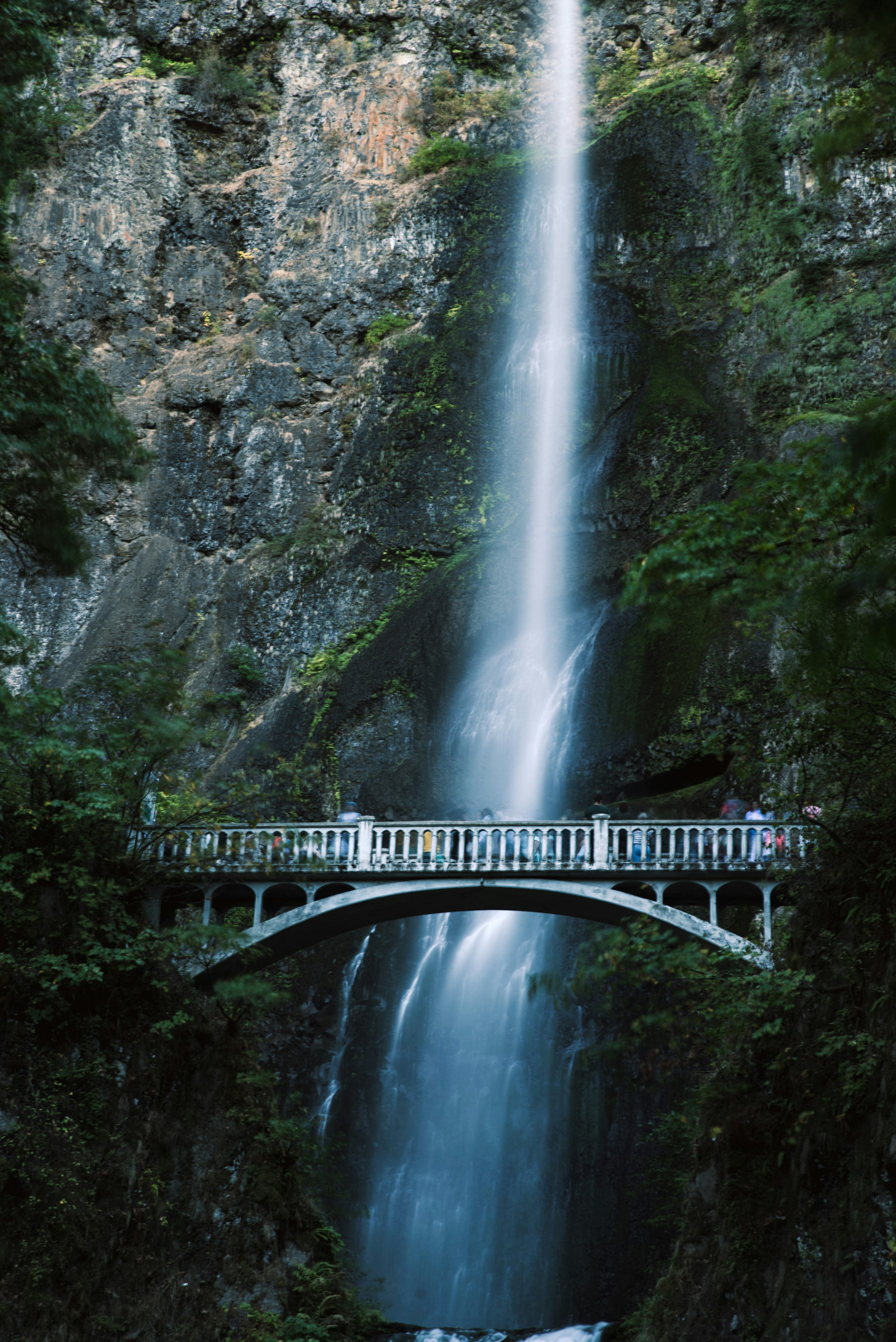 bridge over waterfalls during daytime