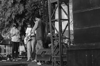 A professional team setting up a stage on a mobile advertising truck with microphones.
