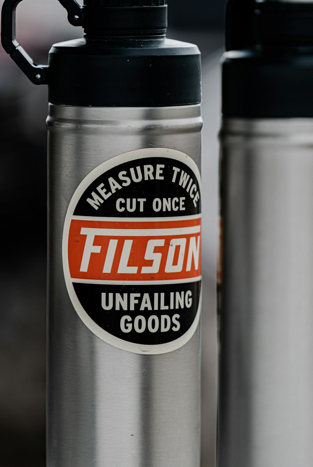 a close up of two stainless steel water bottles