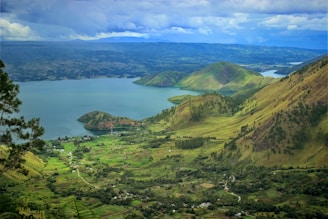 green mountains near body of water during daytime