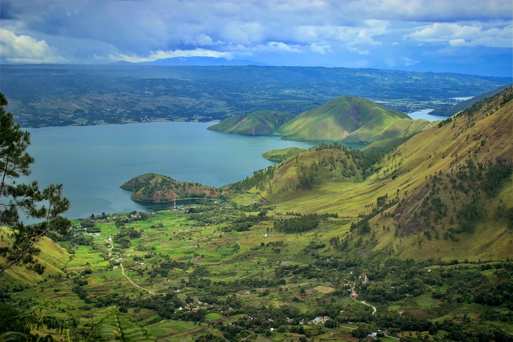 green mountains near body of water during daytime