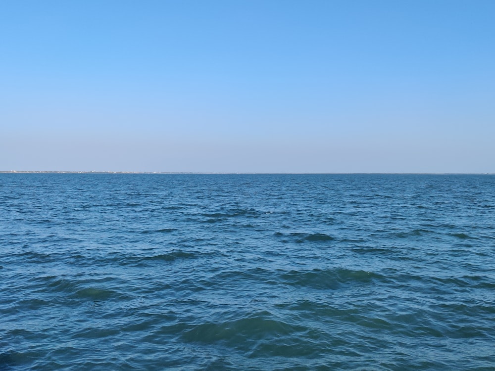 blue ocean water under blue sky during daytime