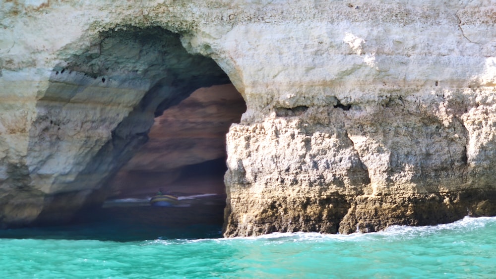 gray rock formation beside body of water during daytime