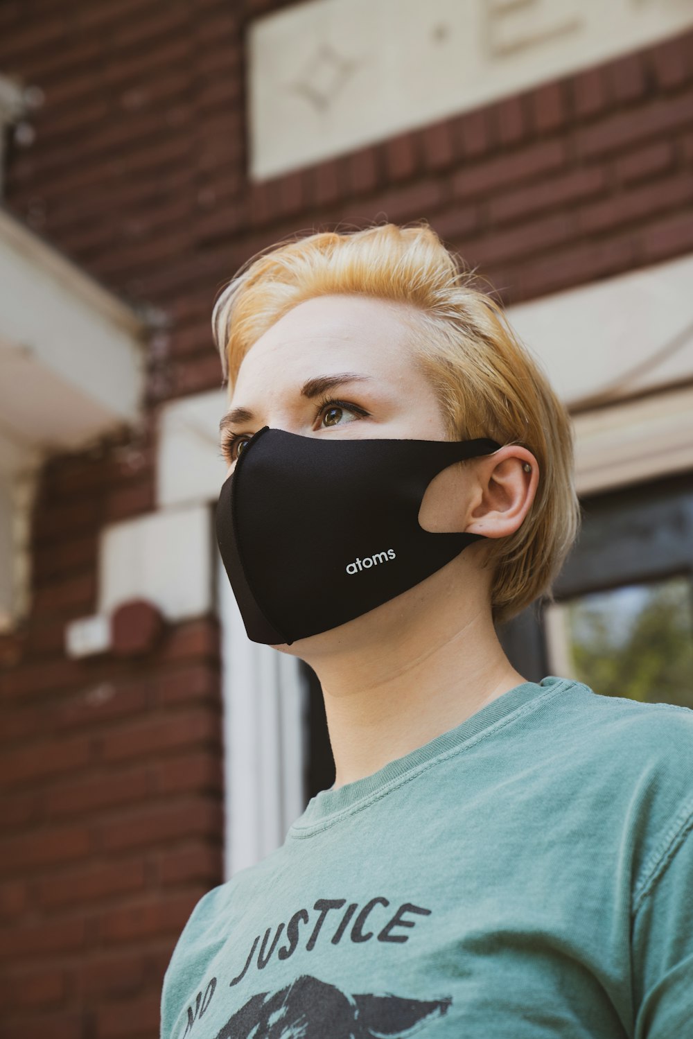 woman in green crew neck shirt wearing black sunglasses