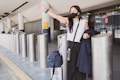 woman in black dress wearing black sunglasses holding white and black walking stick