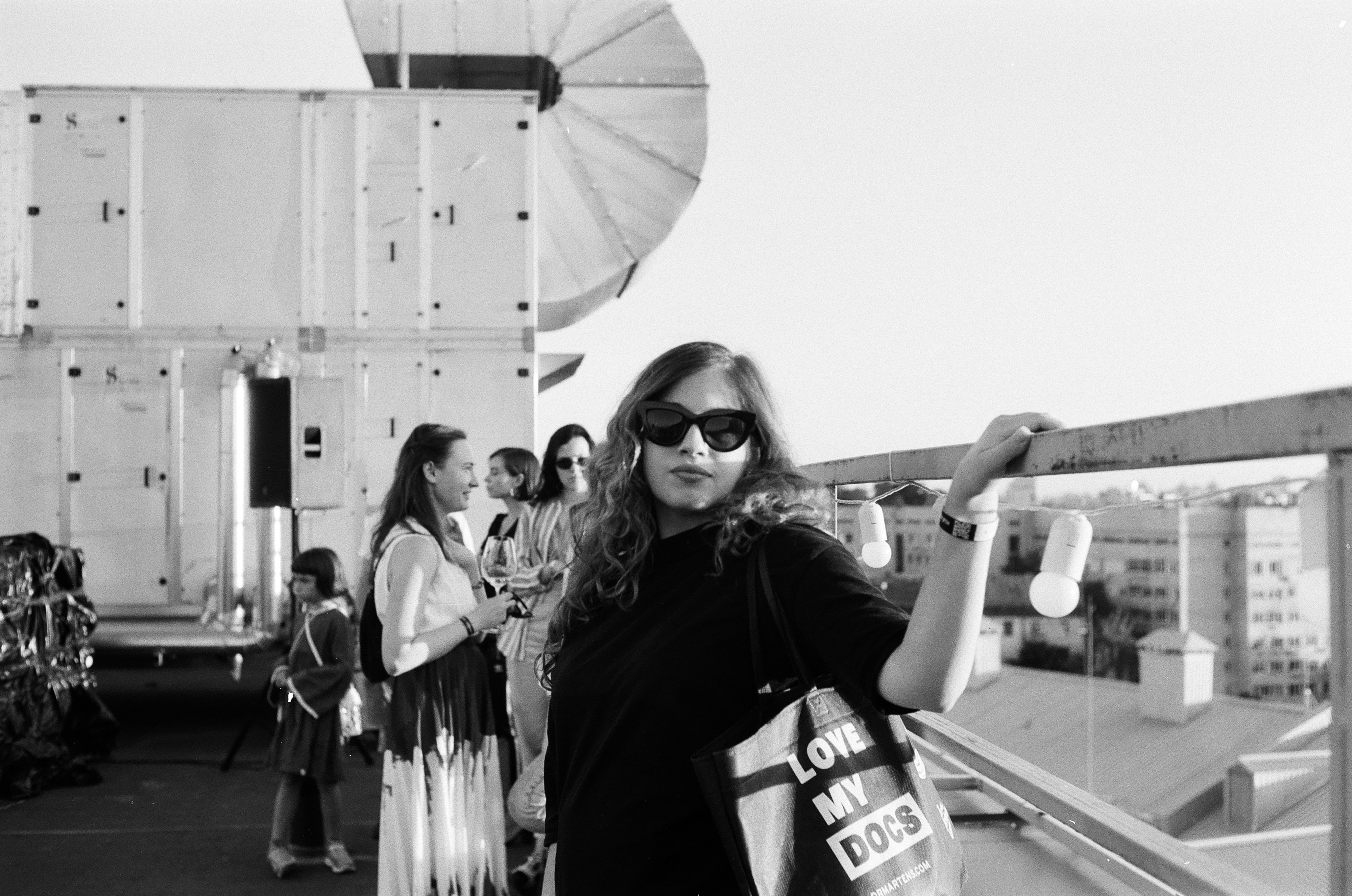 grayscale photo of woman in black long sleeve shirt holding white cup