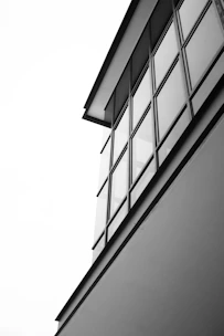 Black and white photo of a modern minimalist architectural building with clean lines.