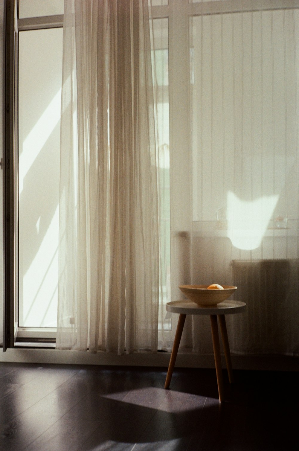 white window curtain near brown wooden table