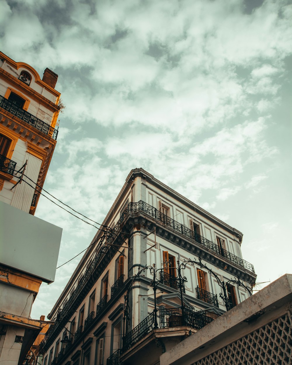 brown concrete building under white clouds during daytime