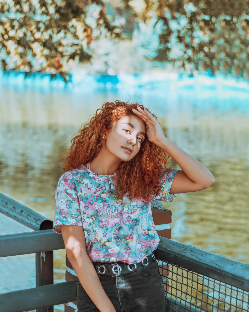 woman in white pink and blue floral sleeveless shirt standing on dock during daytime