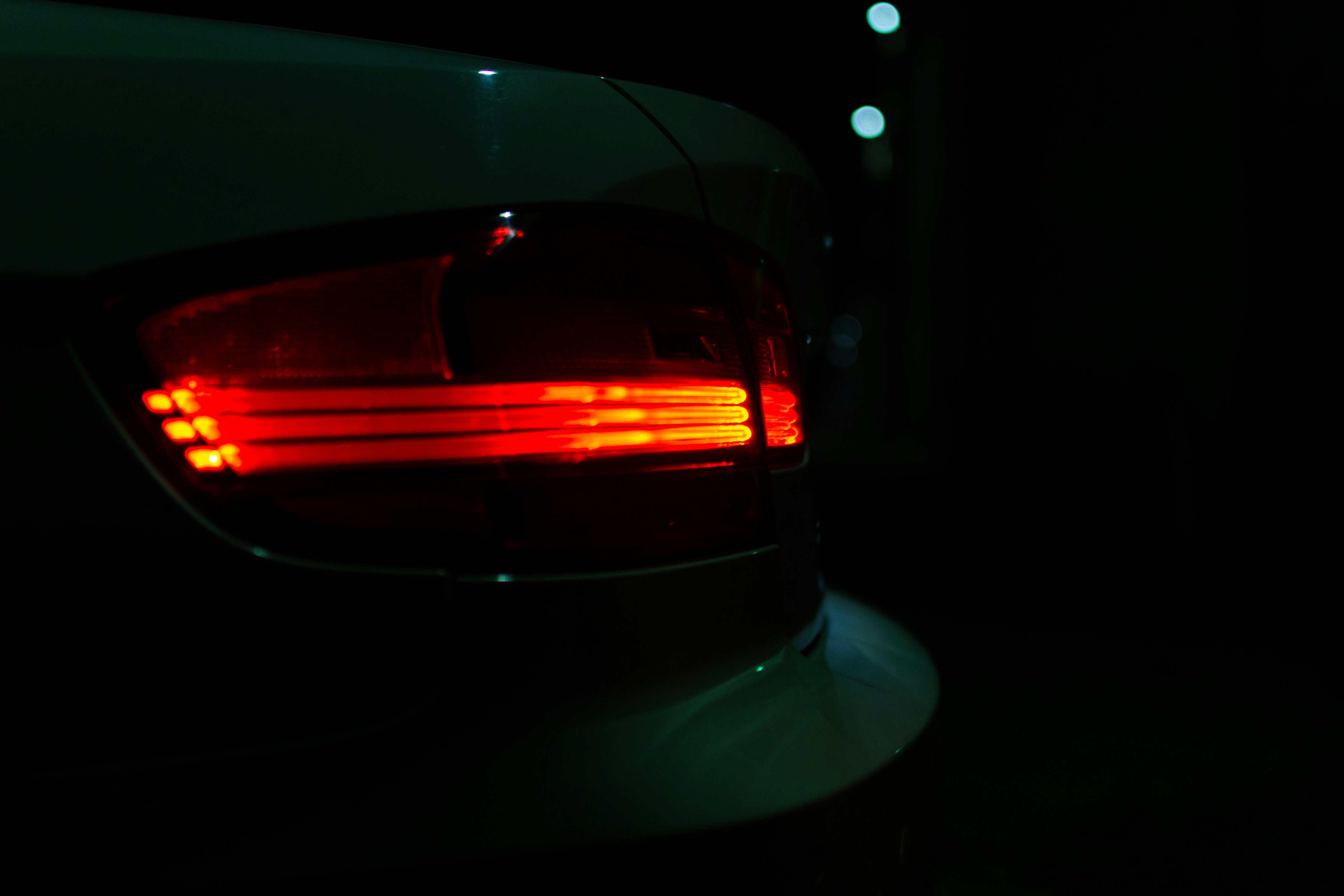 red car on road during night time