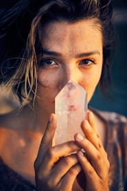 woman holding white paper covering her face