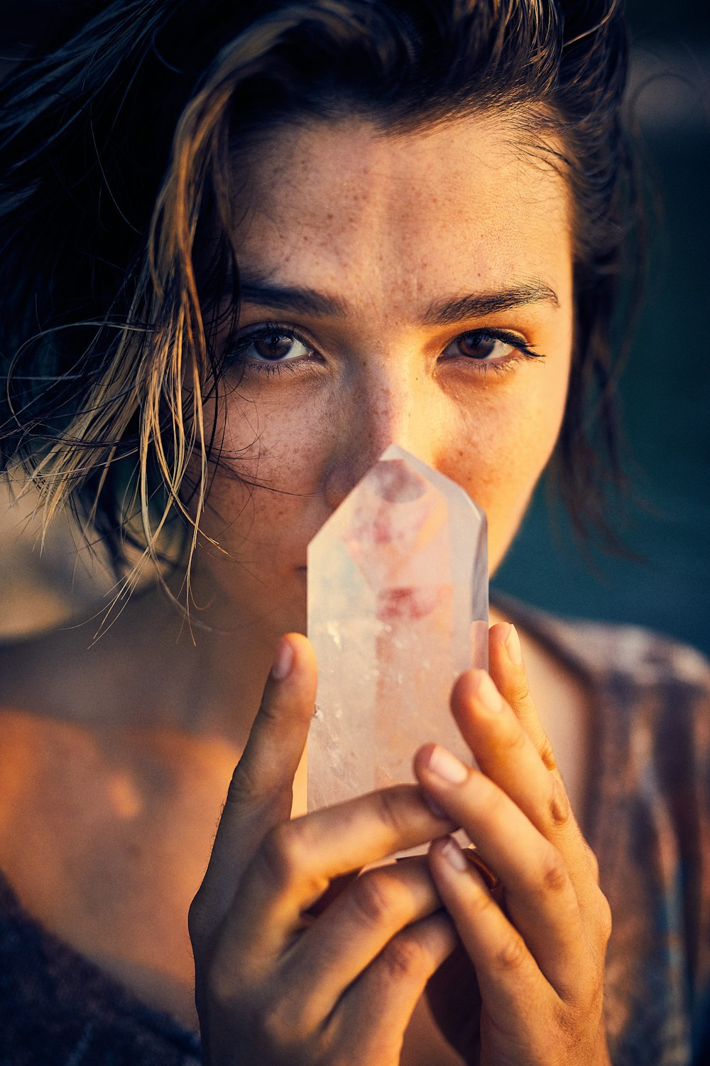 woman holding white paper covering her face