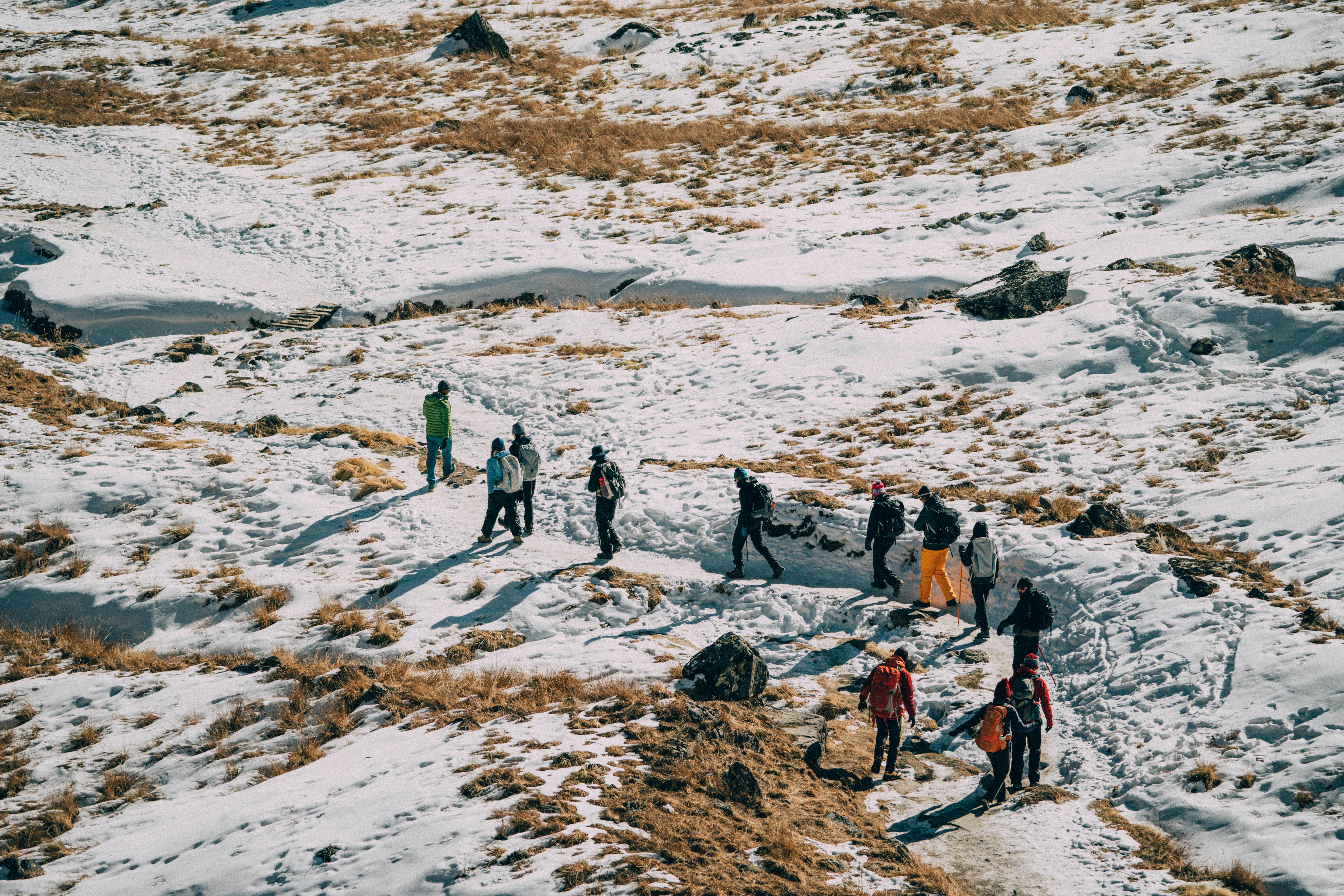 people walking on snow covered field during daytime