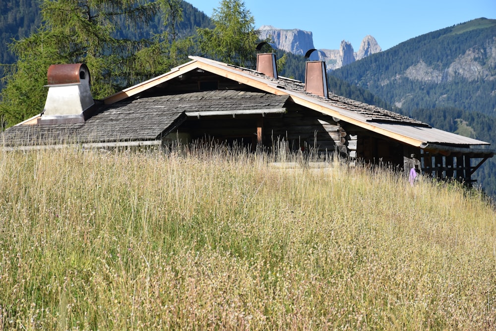 brown wooden house on green grass field during daytime