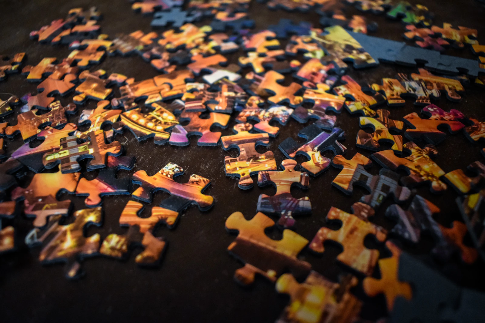 Colorful puzzle pieces scattered and disconnected, some fitting together while others remain isolated against a neutral background