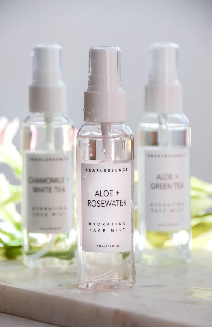 Trio of clear glass mist bottles photographed in soft neutral light