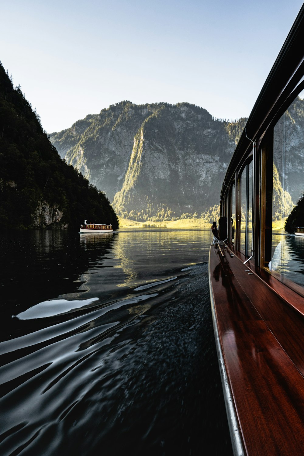 brown wooden boat on lake during daytime