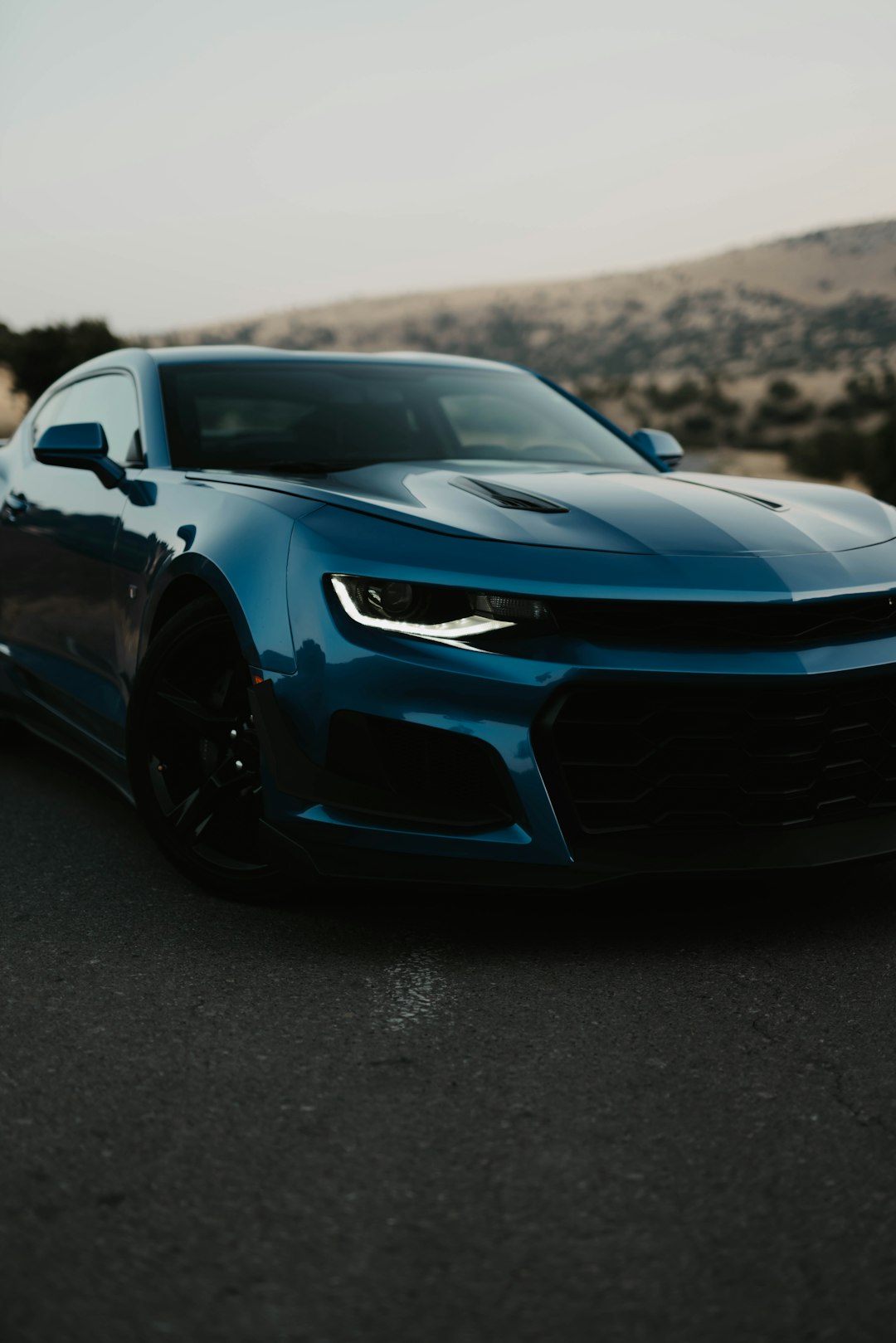 black chevrolet camaro on road during daytime