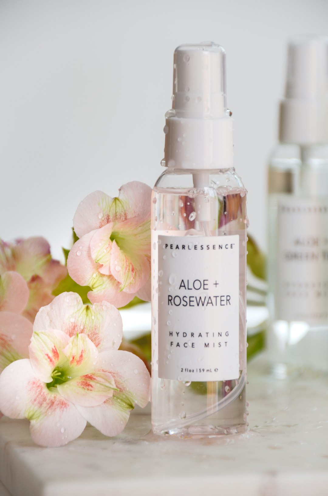 white and purple flowers on clear glass bottles