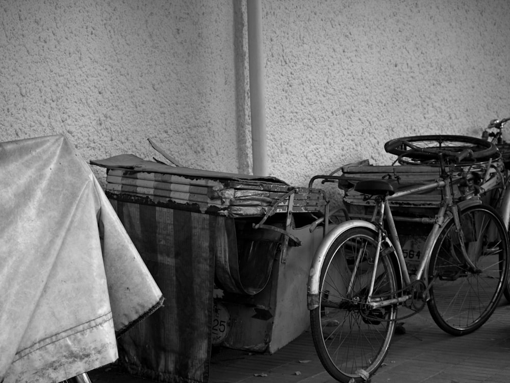 black city bike beside white wall