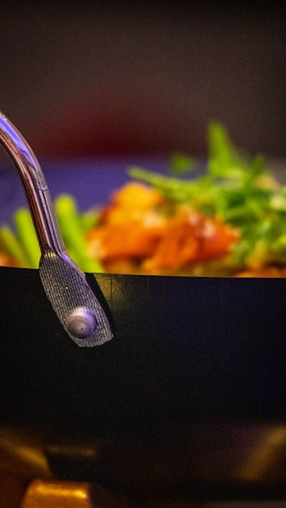 A vibrant close-up of a sizzling pan with colorful vegetables and spices, capturing the essence of home cooking.