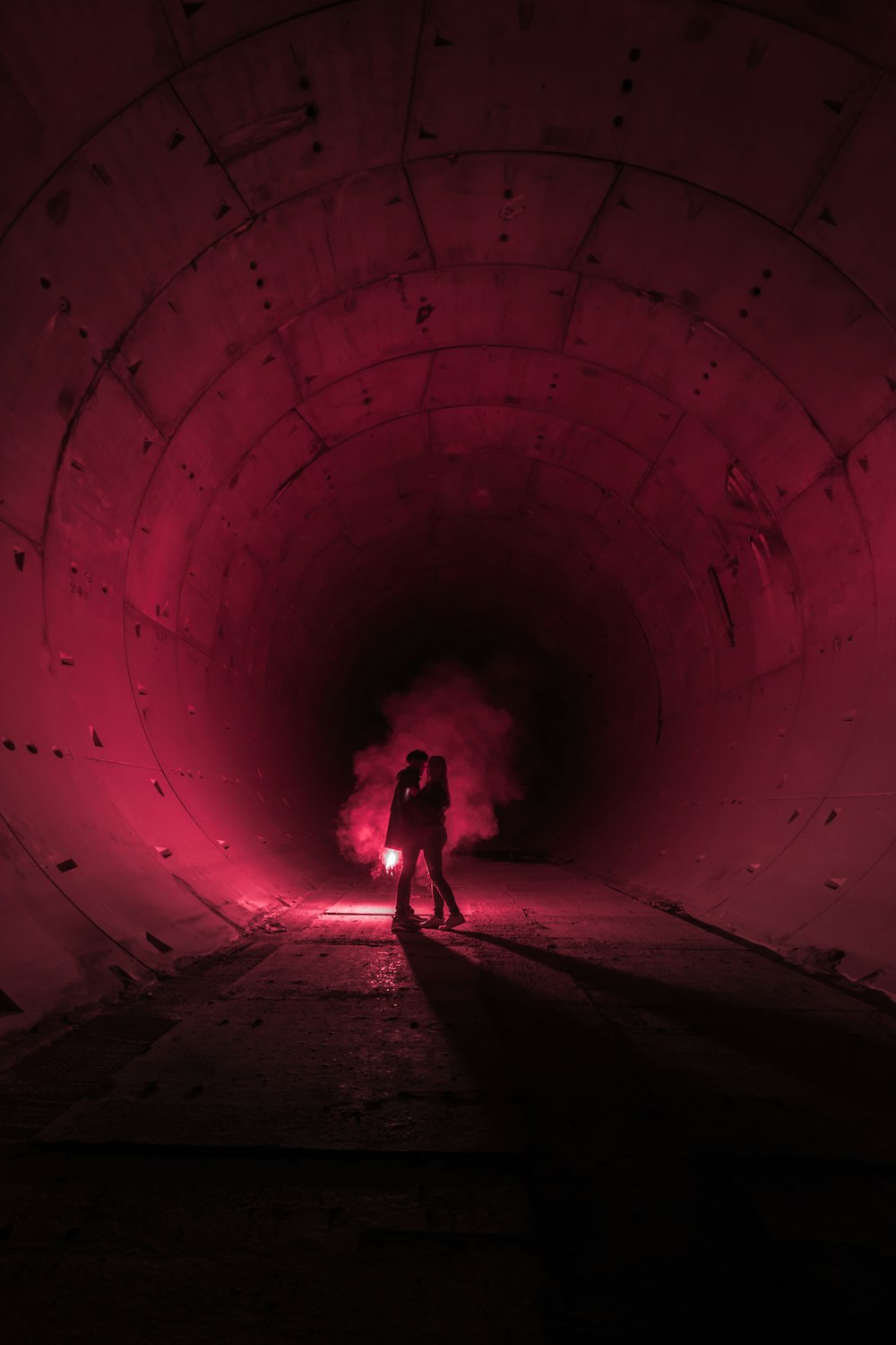 silhouette of person standing on tunnel