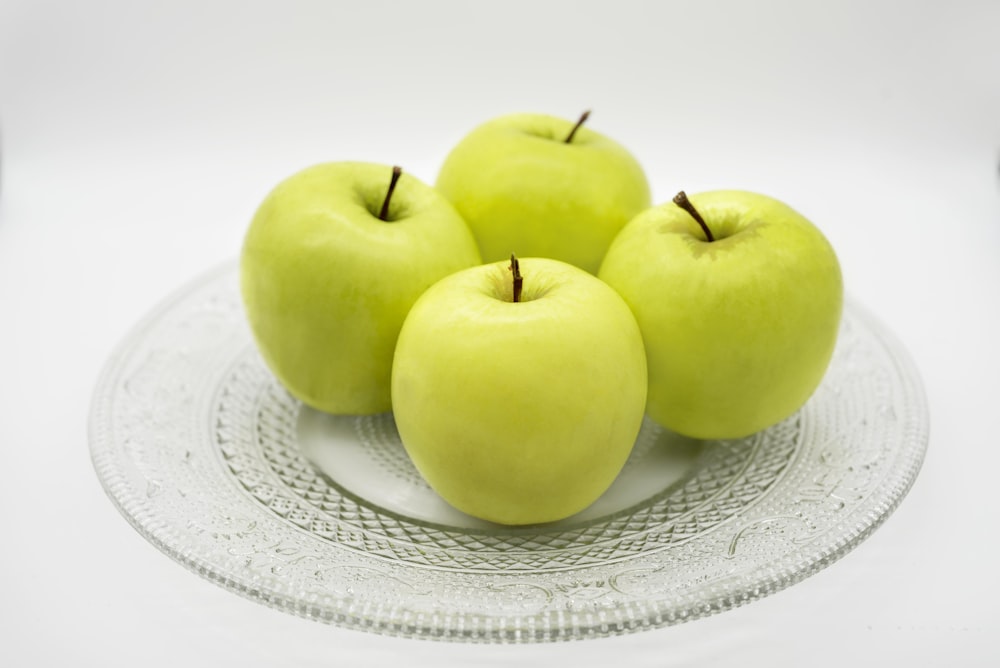 green apple on white and blue floral ceramic plate
