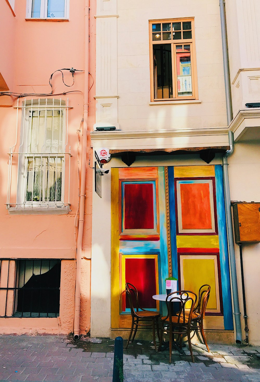 a couple of tables and chairs in front of a building