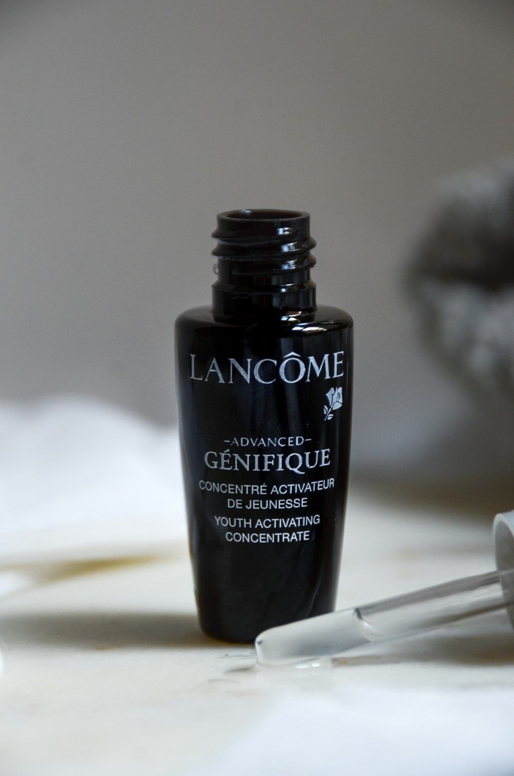 a bottle of lancome advanced genifique on a table