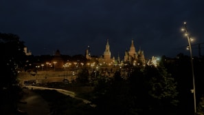 A nighttime cityscape of a popular study abroad destination with university lights glowing.