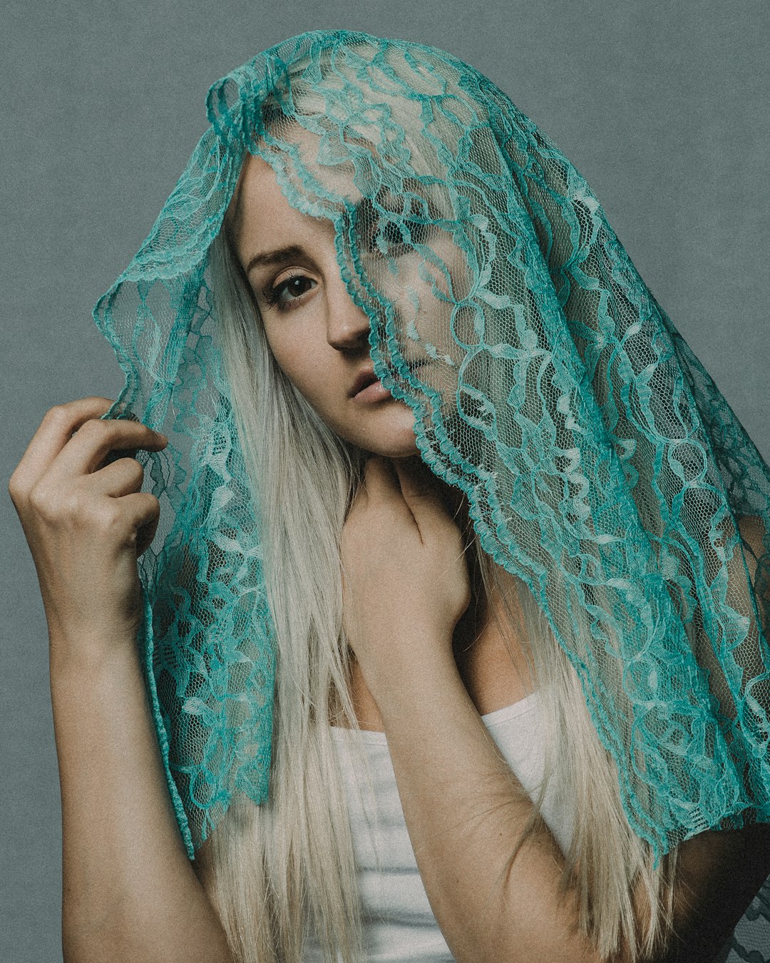 woman in teal and green floral hijab