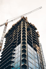 black and white building with yellow crane