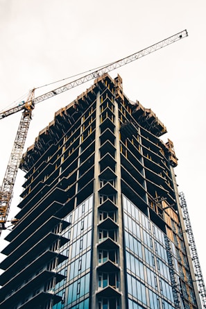 black and white building with yellow crane