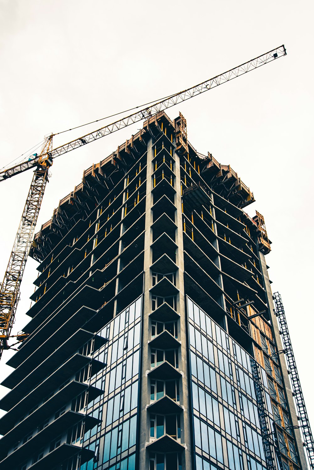 black and white building with yellow crane