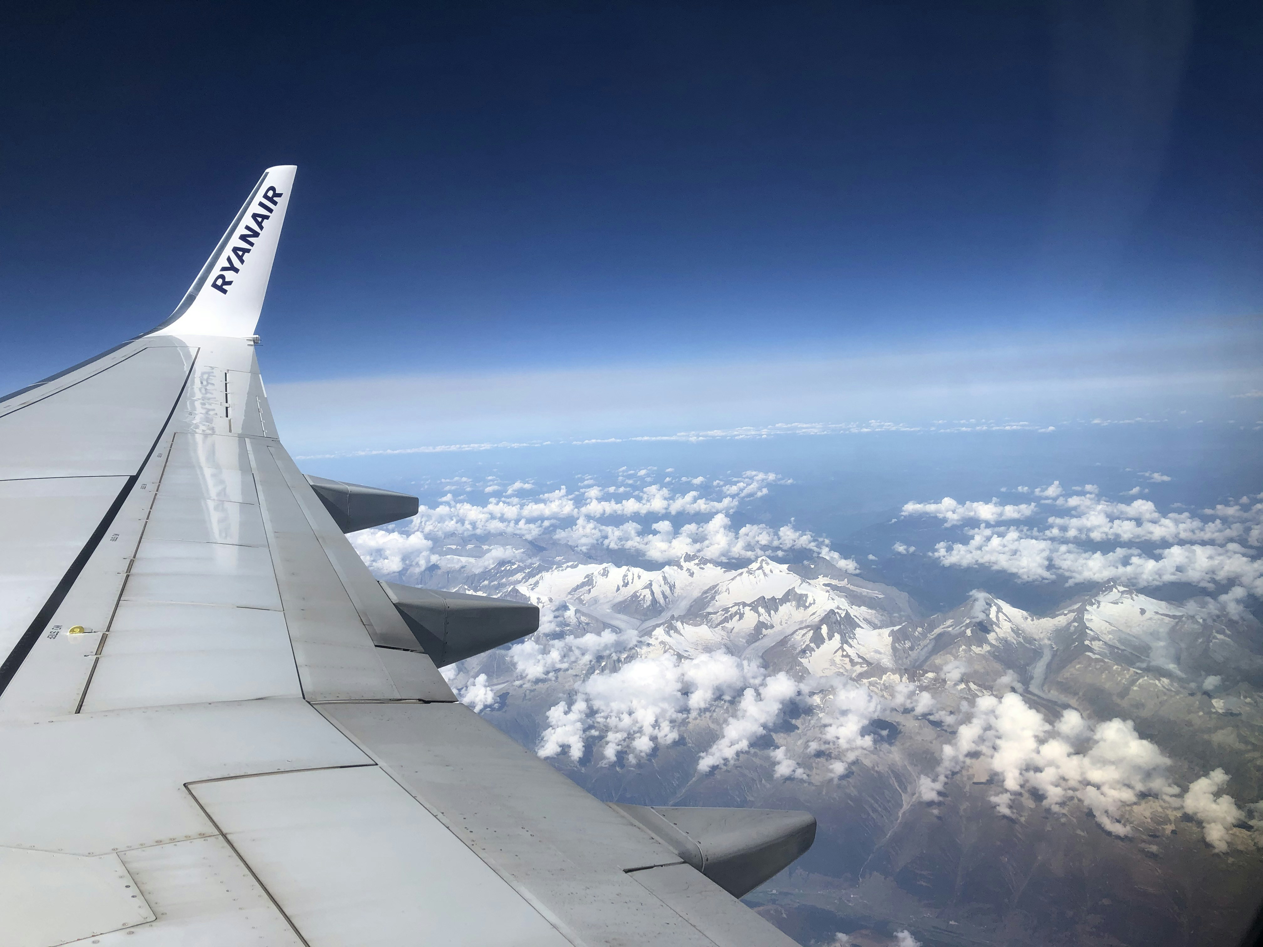 white clouds and blue sky during daytime, A view of the Swiss-Italian Alps from my flight to Rome.