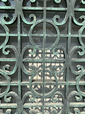 A charming wooden gate with intricate ironwork, newly repaired and polished.