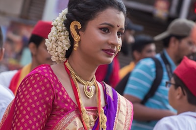 A stylish woman wearing rhodium plated daily wear jewellery in a vibrant Kolkata street.