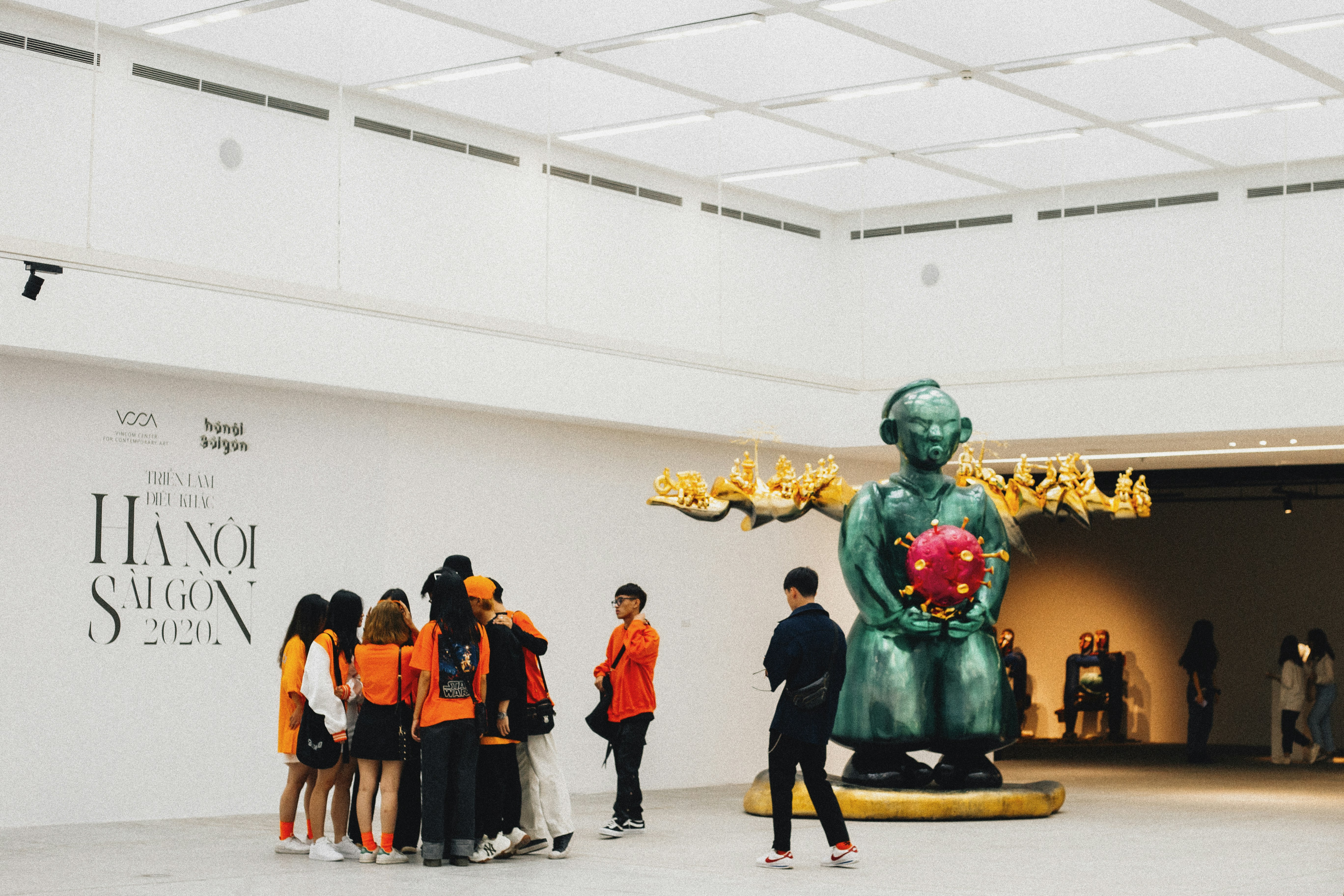 people in green and yellow costume standing on white floor