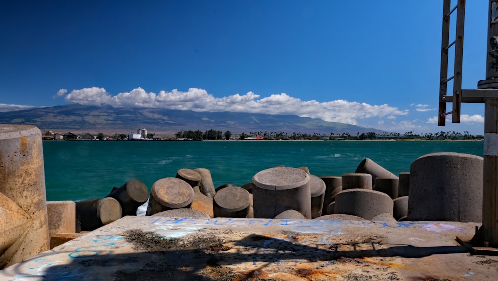 brown rocks on sea shore under blue sky during daytime