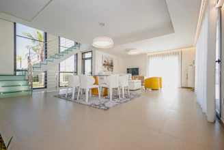 white chairs and table on white floor tiles