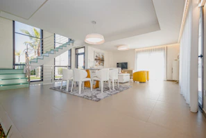 white chairs and table on white floor tiles