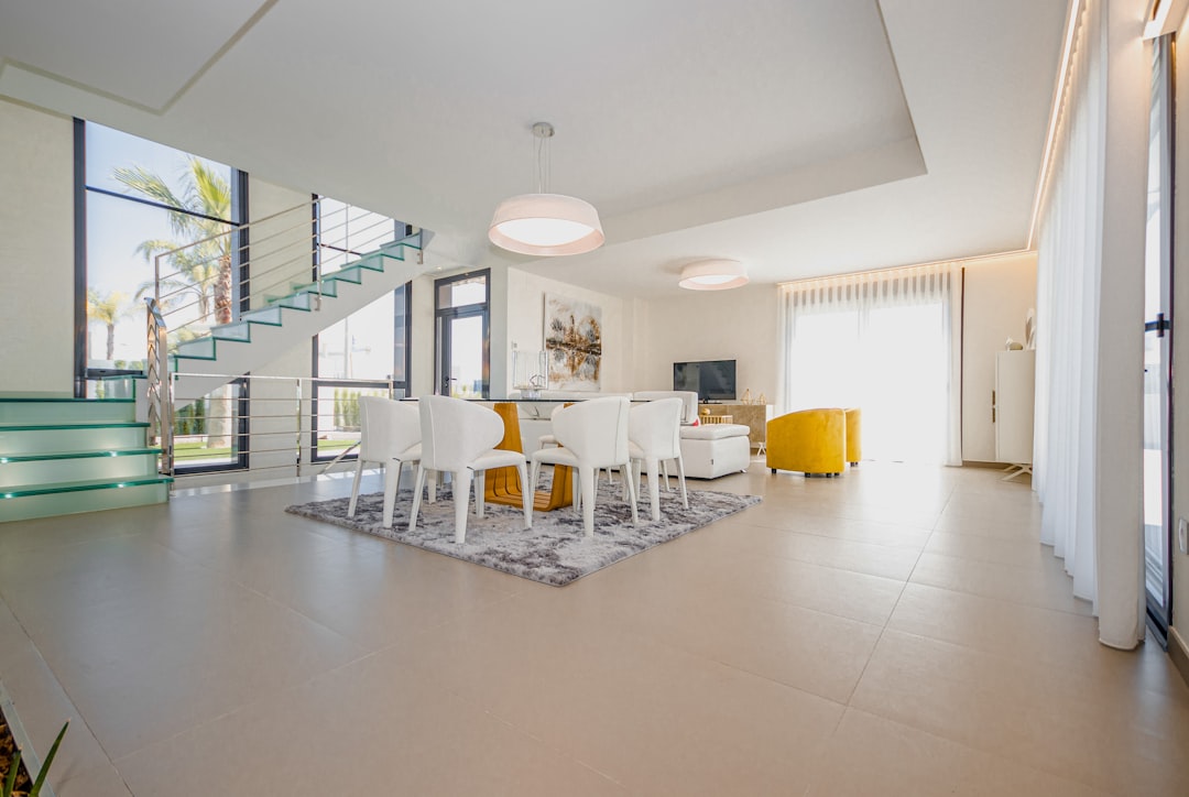 white chairs and table on white floor tiles