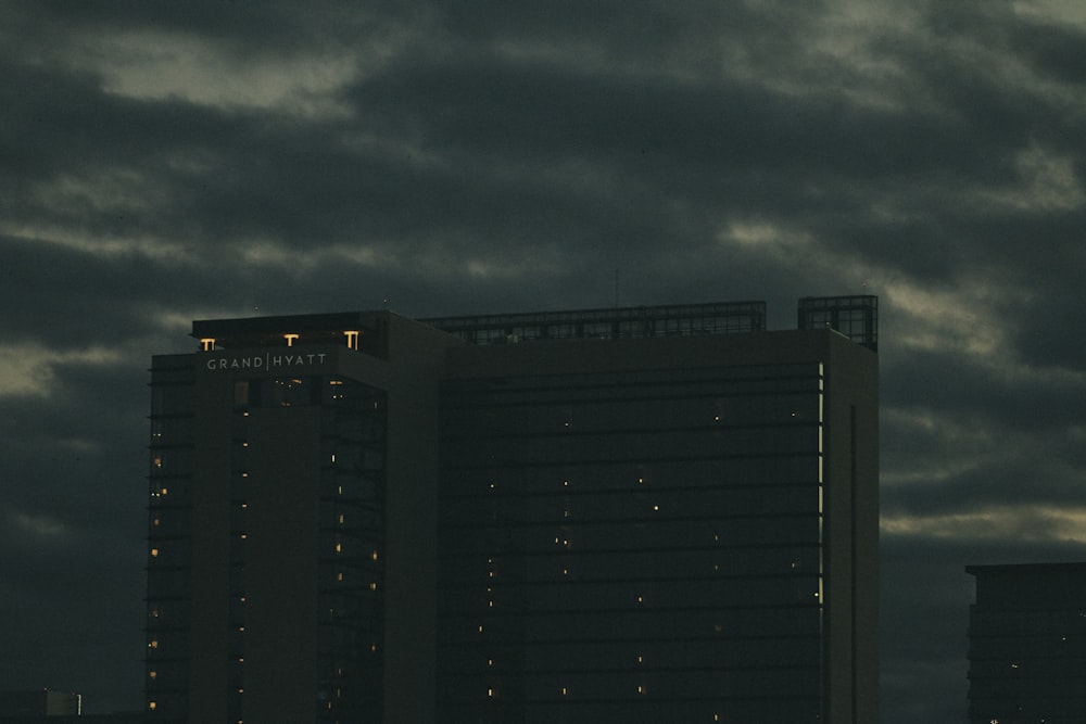 black and gray building under gray clouds