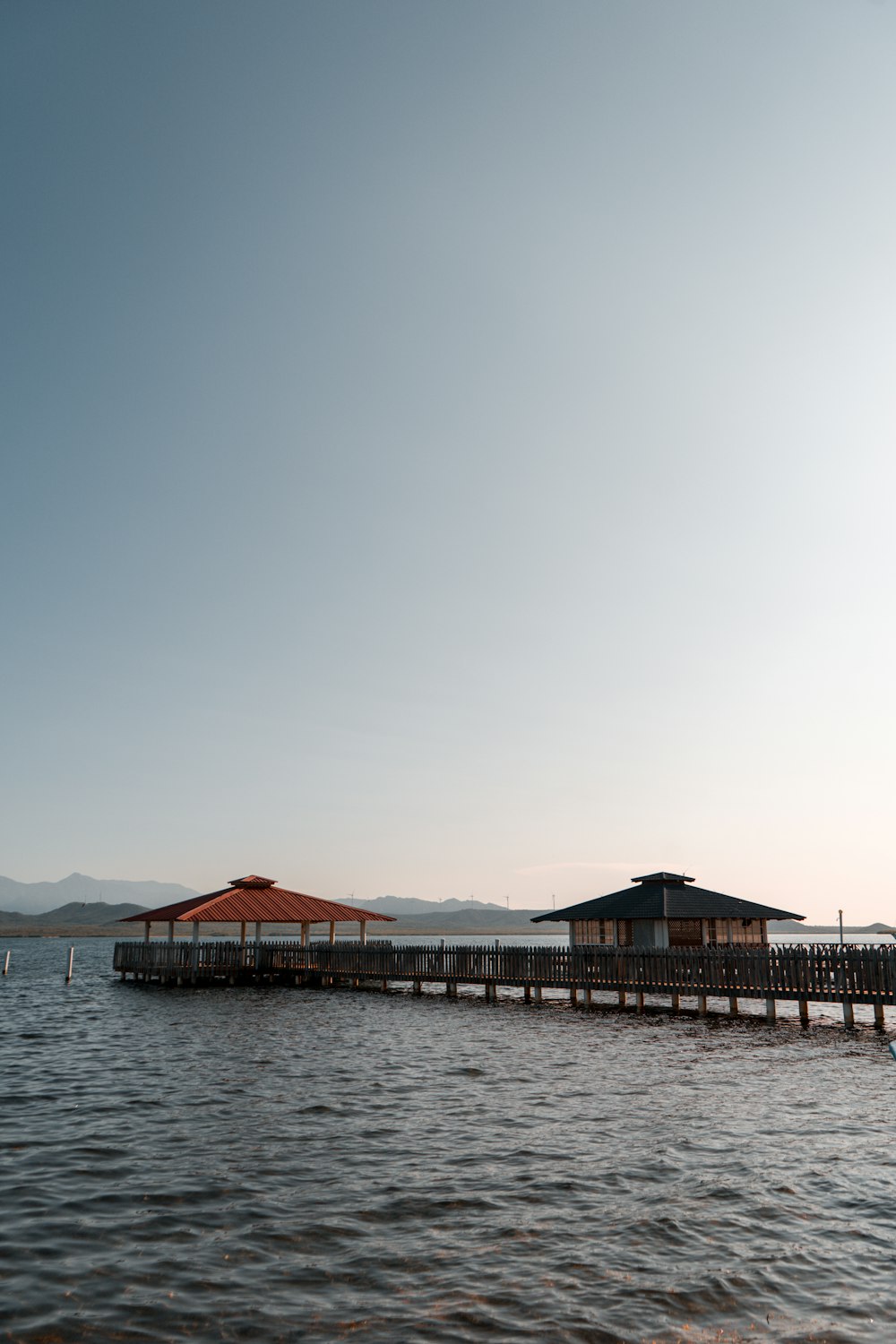 brown wooden dock on body of water during daytime