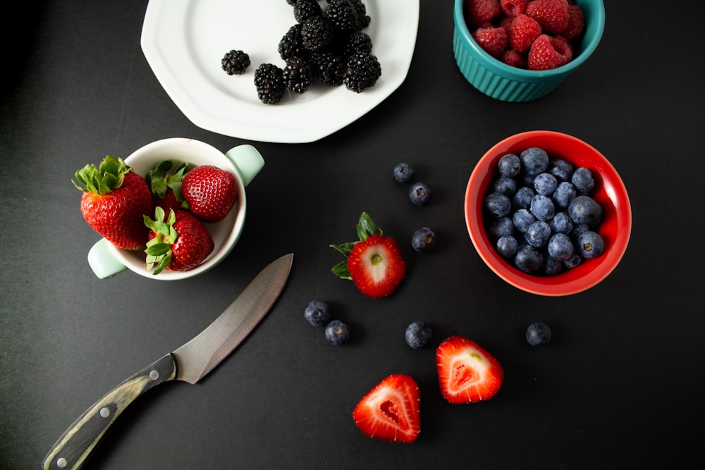 strawberries and blueberries on white ceramic plate