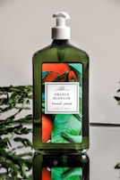 A bottle of narkol hand wash surrounded by fresh green leaves and soft sunlight.